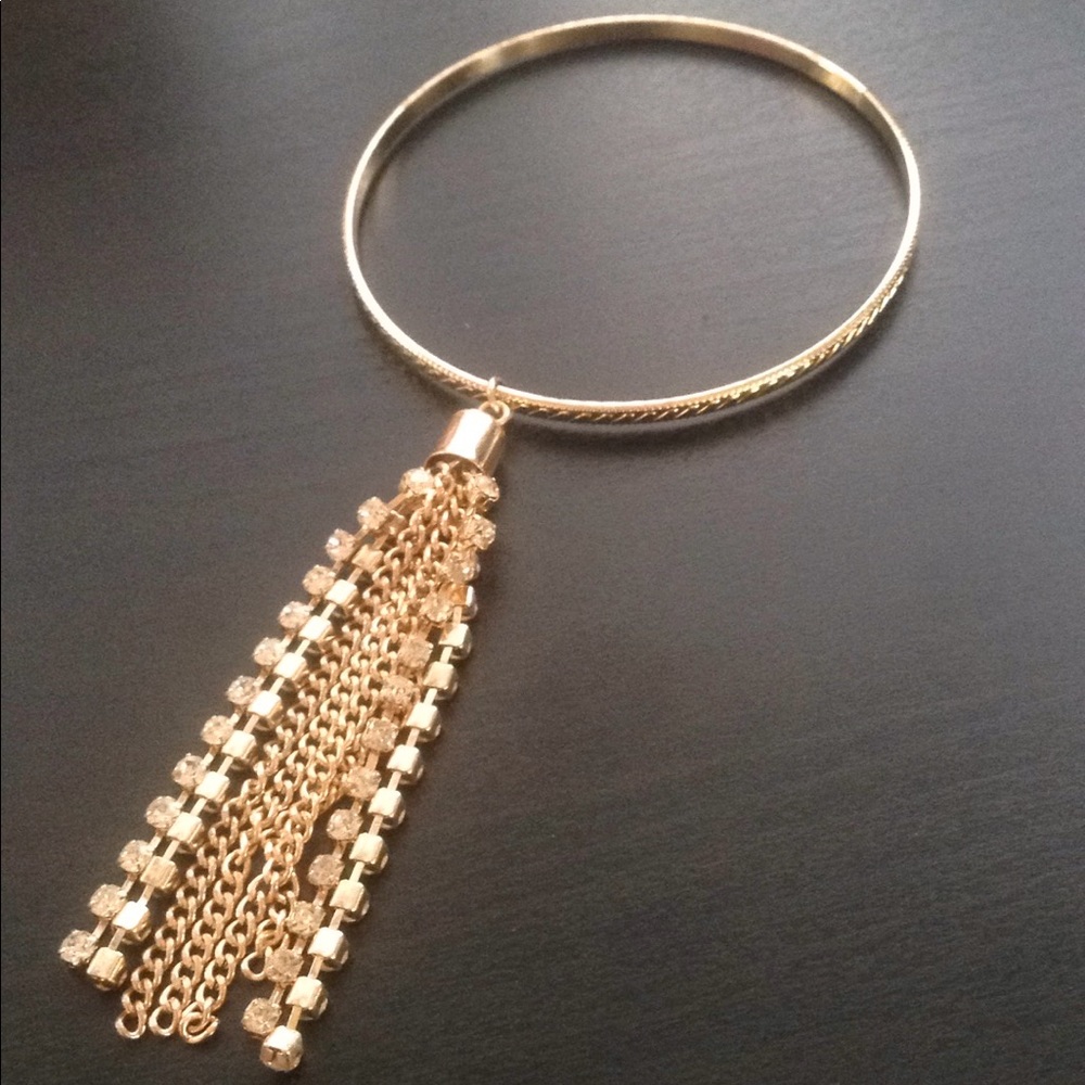 Gold bangle with tassel